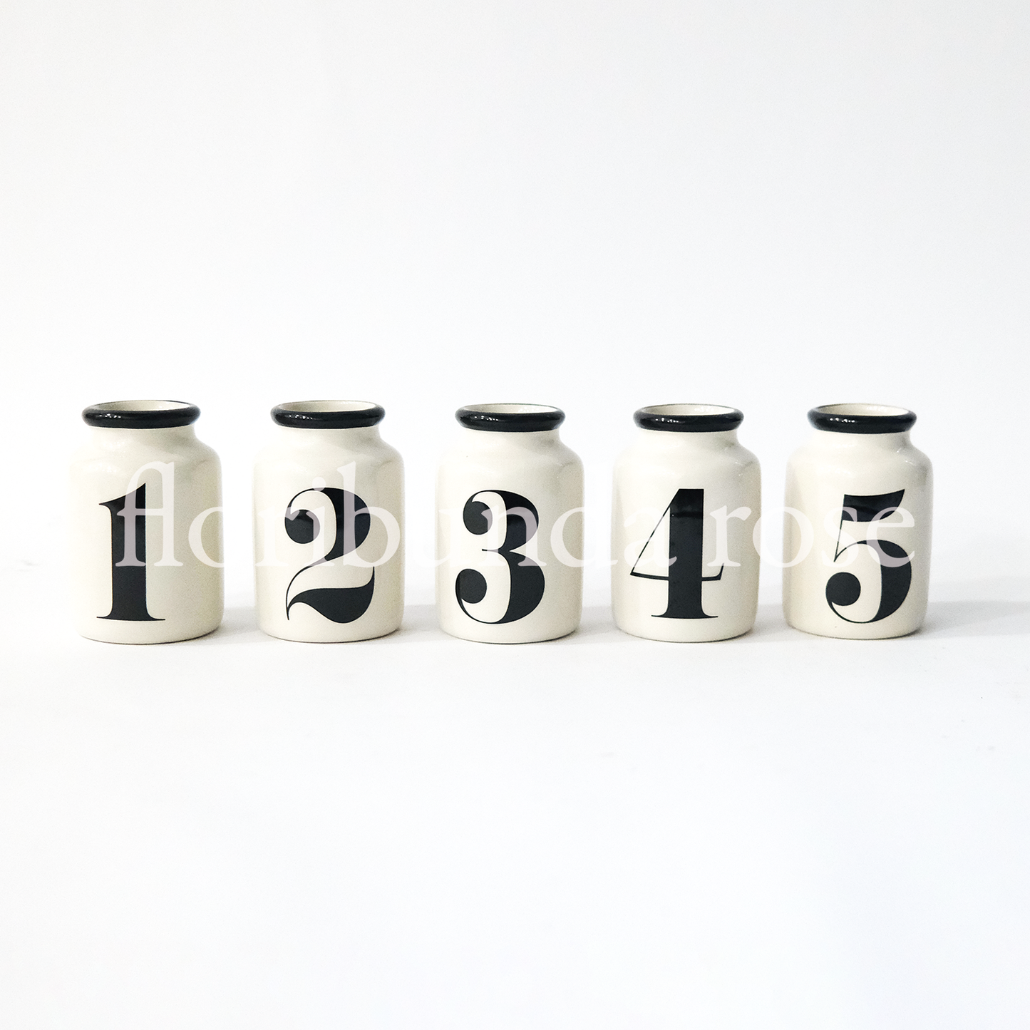 Set of five ceramic numbered vases with black number detail