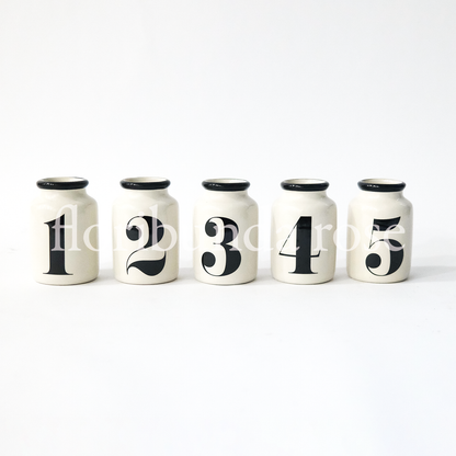Set of five ceramic numbered vases with black number detail